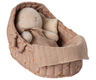 Baby booties in a floral-patterned fabric basket on a white background