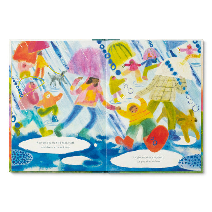 Illustrated book page with children playing in the rain, colorful umbrellas, and rain boots.