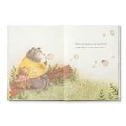 Illustrated book page with two animals sitting together in a forest setting.
