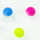 Three colorful gel-like spheres on a white background