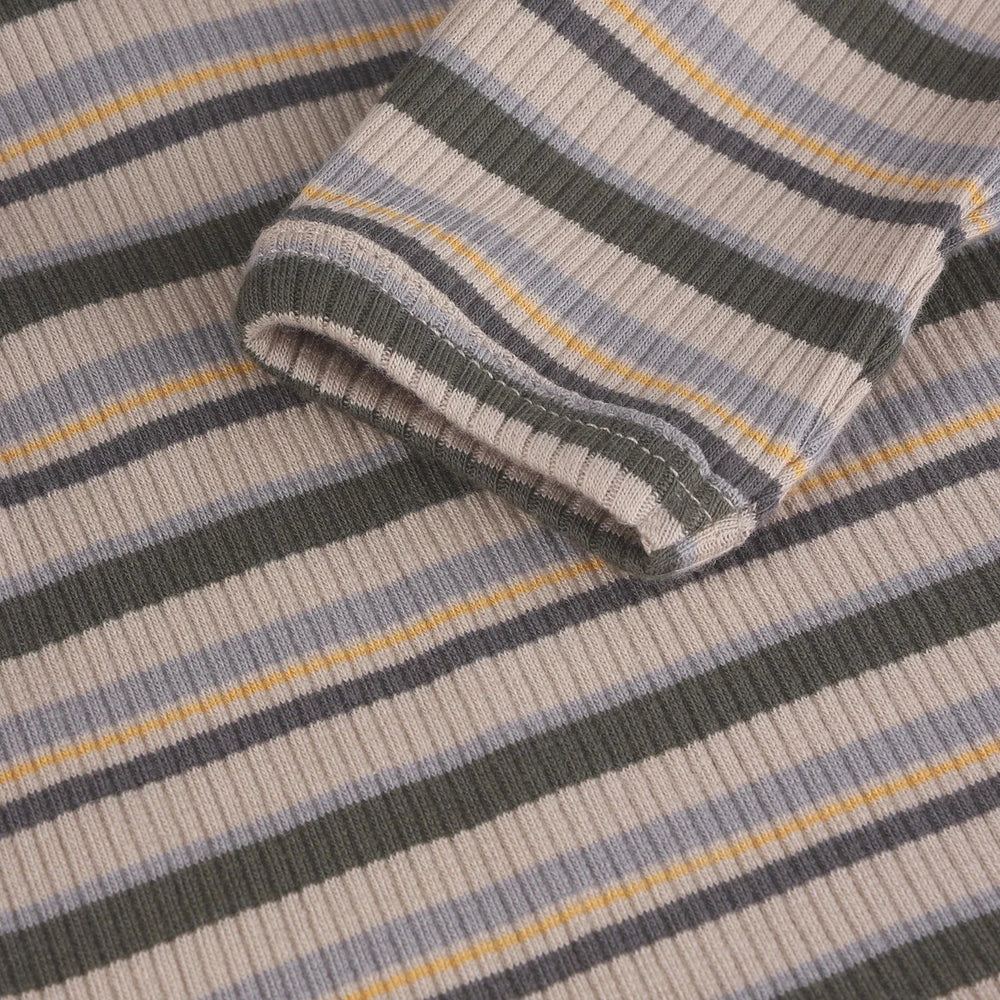 Folded striped fabric with gray, blue, and yellow colors on a matching background.
