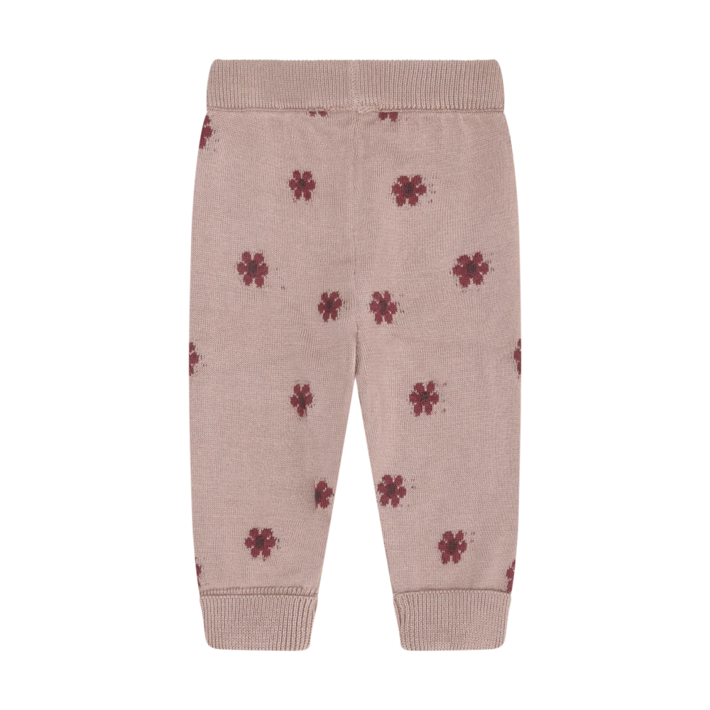 A pair of baby jogger pants in dusty pink, featuring a small dark red floral print and ribbed waistband, leg cuffs, and ankle cuffs.