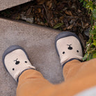 Baby shoes with cartoon design on a stone surface