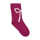 A plum or huckleberry pink sock from the Minymo 3-Pack Socks set (featuring a cute white bow pattern and a wavy ribbed top)