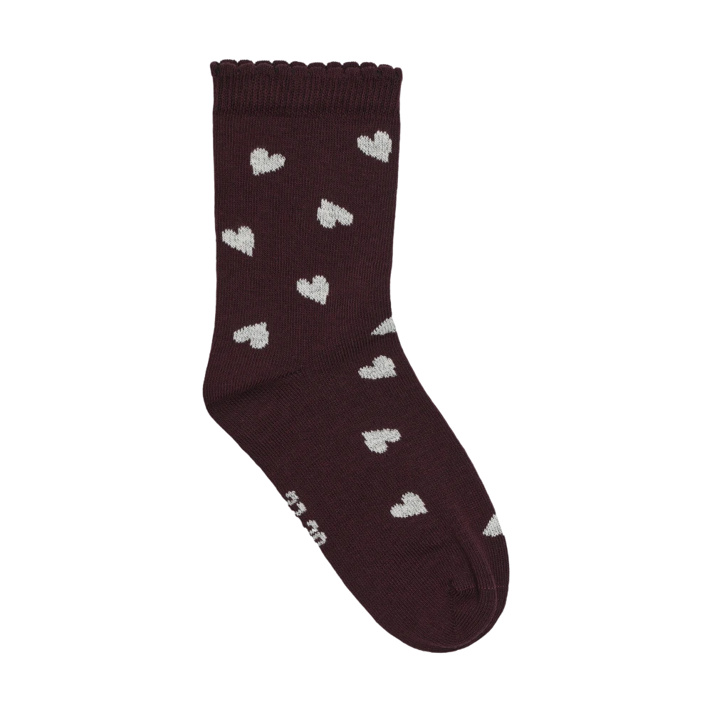 Minymo Socks in a plum/huckleberry shade with small white heart patterns and a wavy ribbed cuff