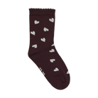 Minymo Socks in a plum/huckleberry shade with small white heart patterns and a wavy ribbed cuff