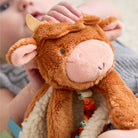 Close-up of a child holding a brown plush toy with a soft texture.