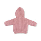 Pink knitted baby hoodie on a white background