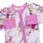 A baby long-sleeve zip-up sleeper with a white background and a colorful floral print, featuring solid pink trim, collar, cuffs, and front zipper.