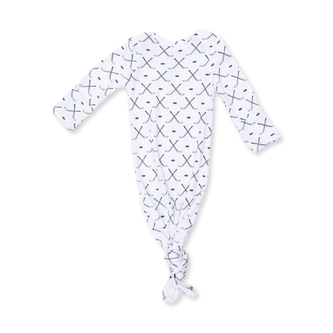 A white long-sleeve baby footed sleeper with a tie closure at the foot, featuring a repeating pattern of small black crosses and dots, shown on a plain white background.