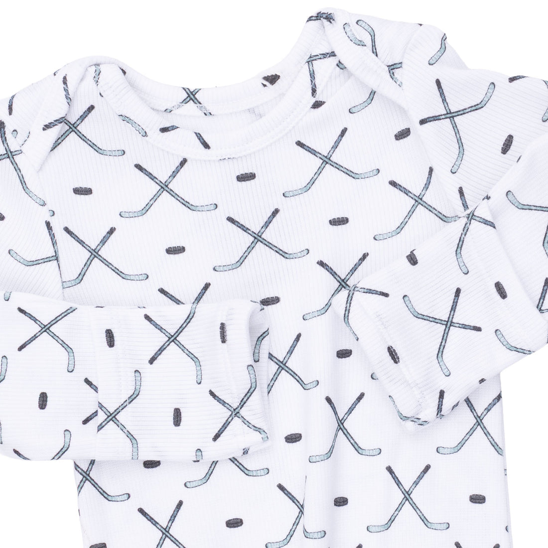 White long-sleeve baby t-shirt with an all-over hockey stick and dot pattern in gray and black.