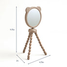 Small round mirror with a wooden stand on a white background, showing dimensions.
