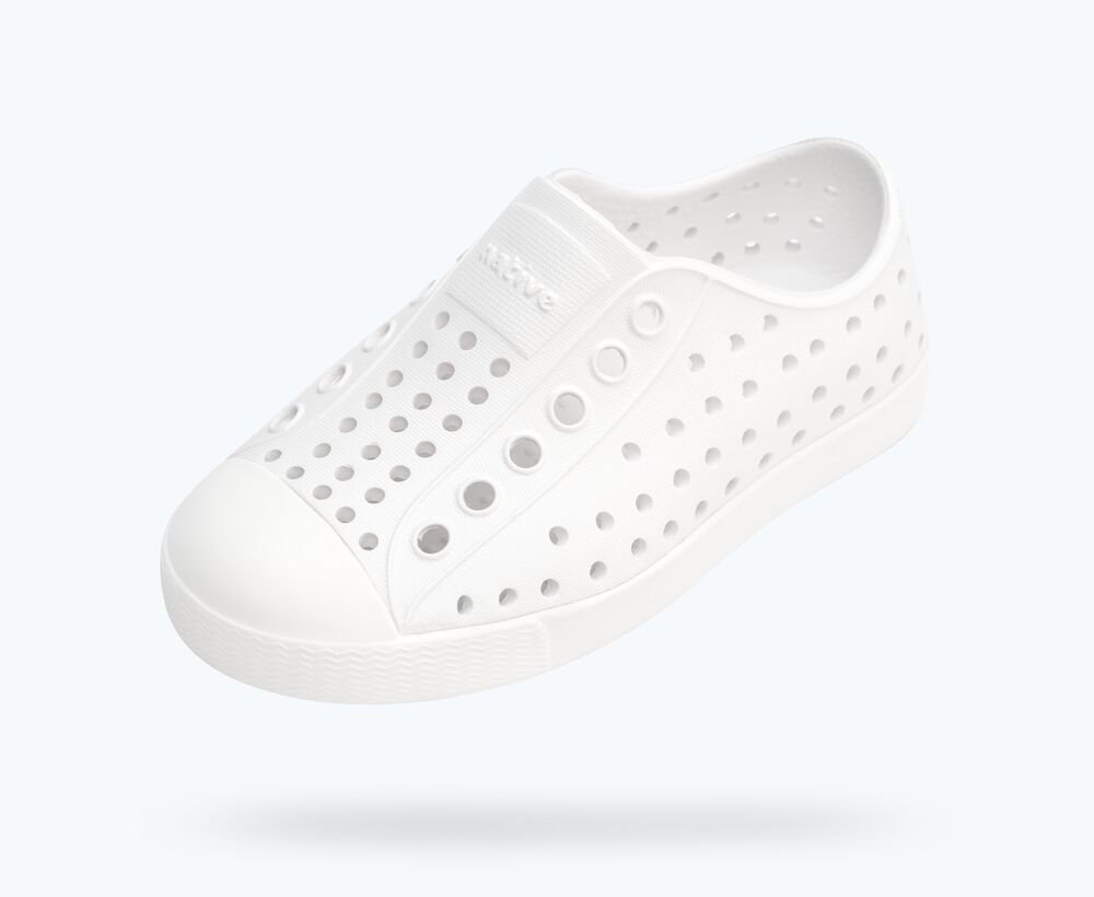 White sneaker with small holes on a white background