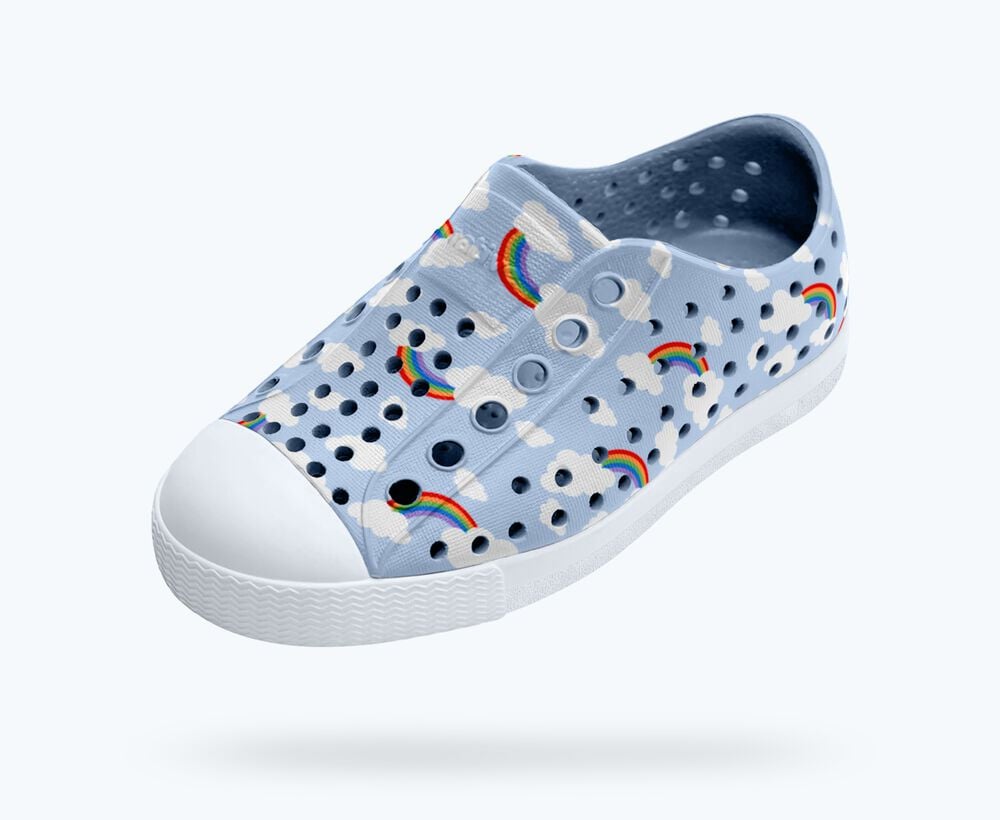 Children's shoe with rainbow and cloud pattern on a white background