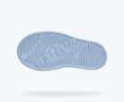Purple sole of a shoe with visible brand logo on a light gray background