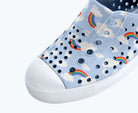 Light blue shoe with rainbow and cloud pattern on a white background