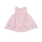 Pink dress with cherry embroidery on a white background