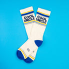 White socks with 'Cool Uncle' text on a blue background