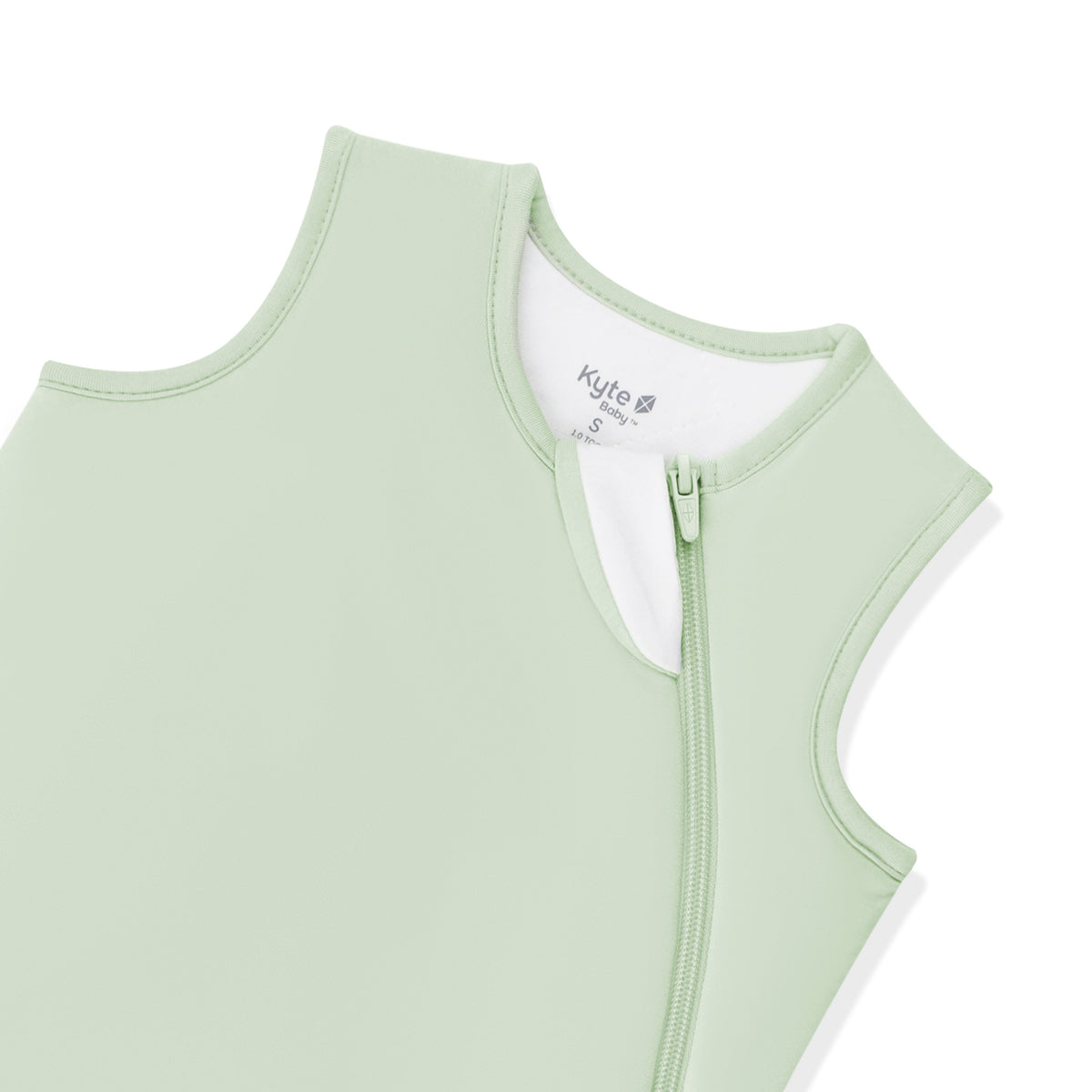 Light green baby romper with a zipper on a white background