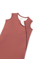 A close-up of a terracotta-colored protective cover or sleeve with zipper, shown on a plain white background.