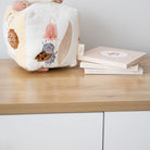 Children's soft book with illustrations on a wooden surface