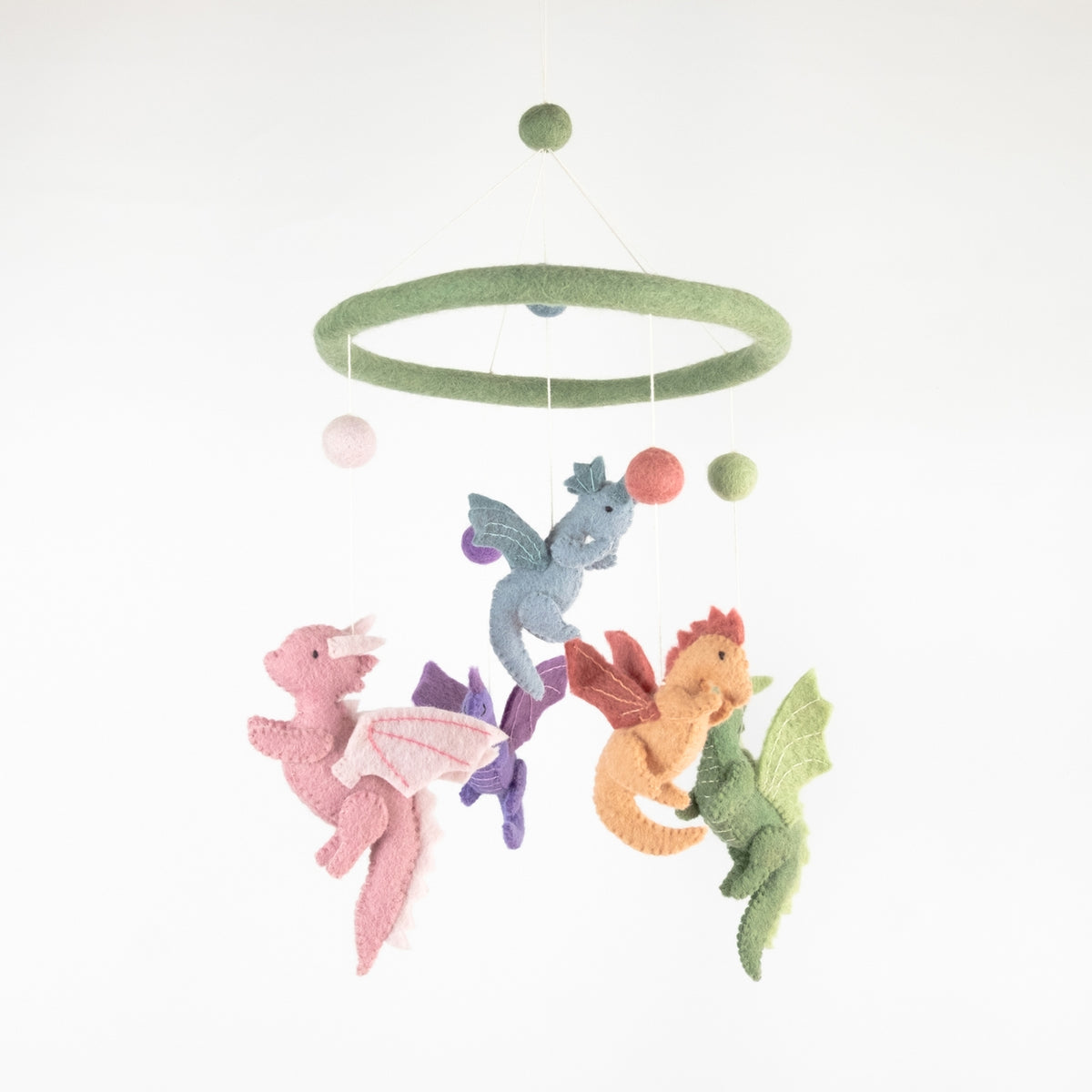 A felt baby mobile with a green circular ring and hanging dragons in pink, blue, orange, and green, suspended against a plain white background.