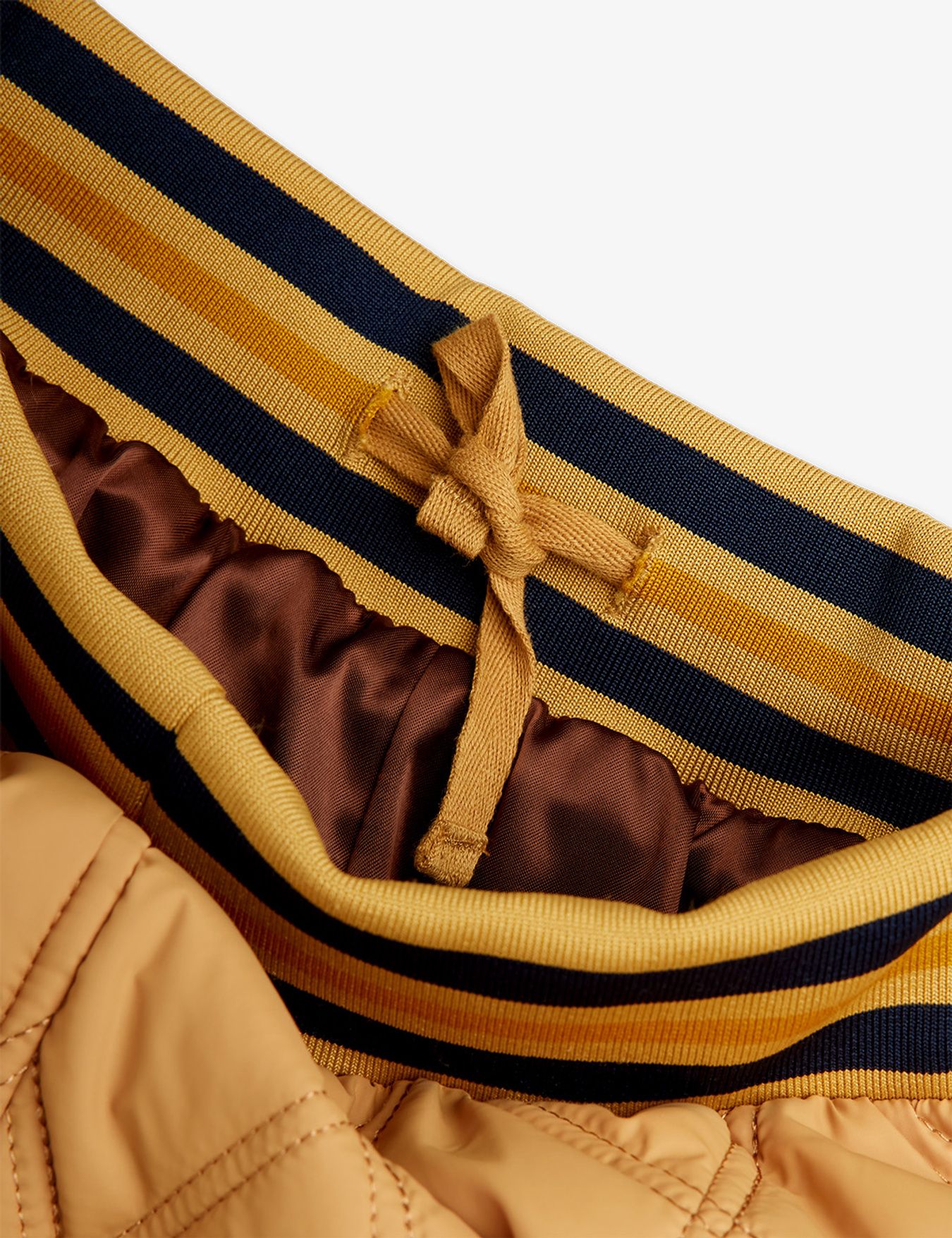 Close-up of a striped garment with a bow detail on a white background