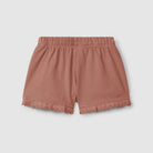Pink shorts with ruffled edges on a light gray background