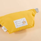 Yellow pouch with a label on a beige background