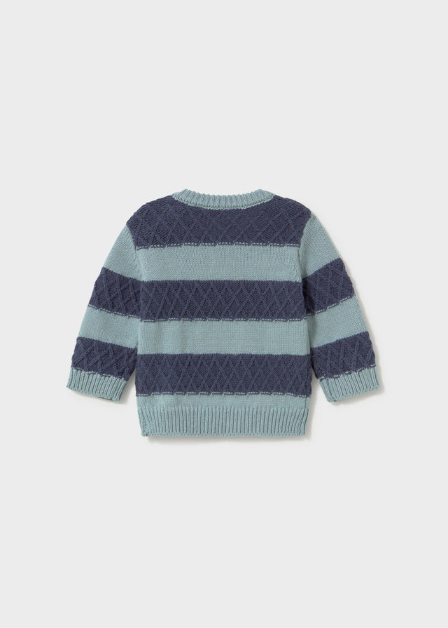 A striped knit sweater shown from the back, featuring horizontal bands of navy blue and light blue-gray with a textured diamond pattern.