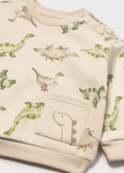 Beige sweater with dinosaur prints on a white background
