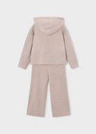 A two-piece children's knit loungewear set in a light beige color, featuring a hooded sweatshirt and matching wide-leg pants, shown from the back on a light gray background.