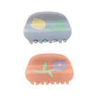 Two hair clips with floral designs on a white background