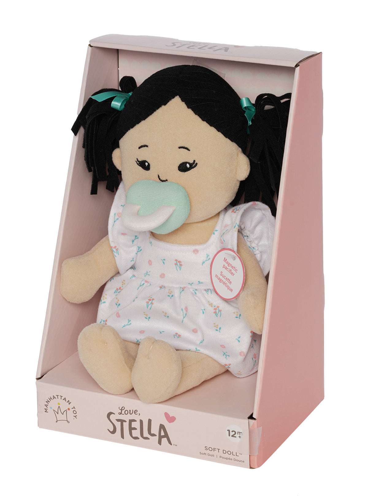 Stella soft doll in packaging with pacifier and dark hair in pigtails