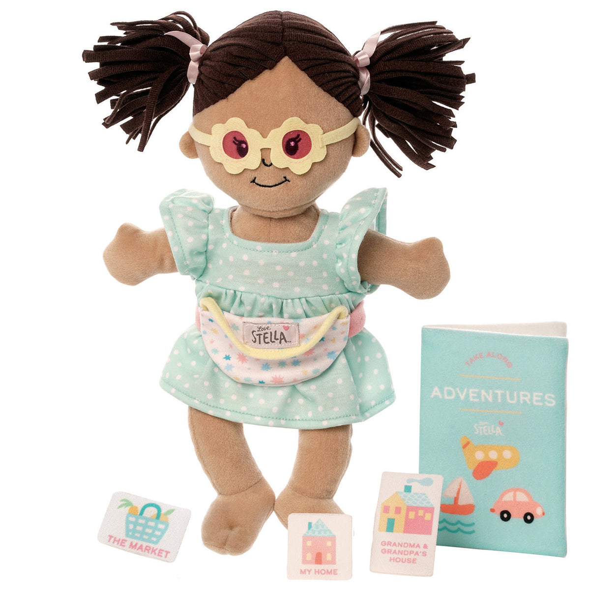 Doll with pigtails wearing glasses and a dress, accompanied by a book titled 'Adventures' on a white background.