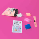 Air dry clay kit with packaging, clay blocks, and instructions on a pink background