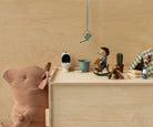 Wooden toy set with a bear, teddy bear, and other small items on a wooden surface.