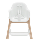 A high chair with a white molded seat and footrest, supported by a light natural wood frame, shown from the back on a white background.