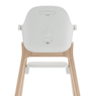 The back view of a modern high chair with a white molded plastic seat and a light natural wood frame, shown against a solid white background.