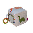 Children's toy cube with various textures and shapes on a white background
