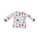 A long-sleeve baby shirt with a white base and an all-over sports-themed print featuring footballs, jerseys, helmets, and foam fingers in multiple colors, finished with solid blue cuffs.