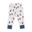 White kids' jogger pants with an all-over hockey player print and solid navy blue cuffed hems, shown flat on a white background.