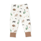 White children's jogger pants with an all-over woodland animal print including moose, bison, bears, and trees, finished with solid tan ankle cuffs.