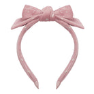 Pink headband with a bow on a white background