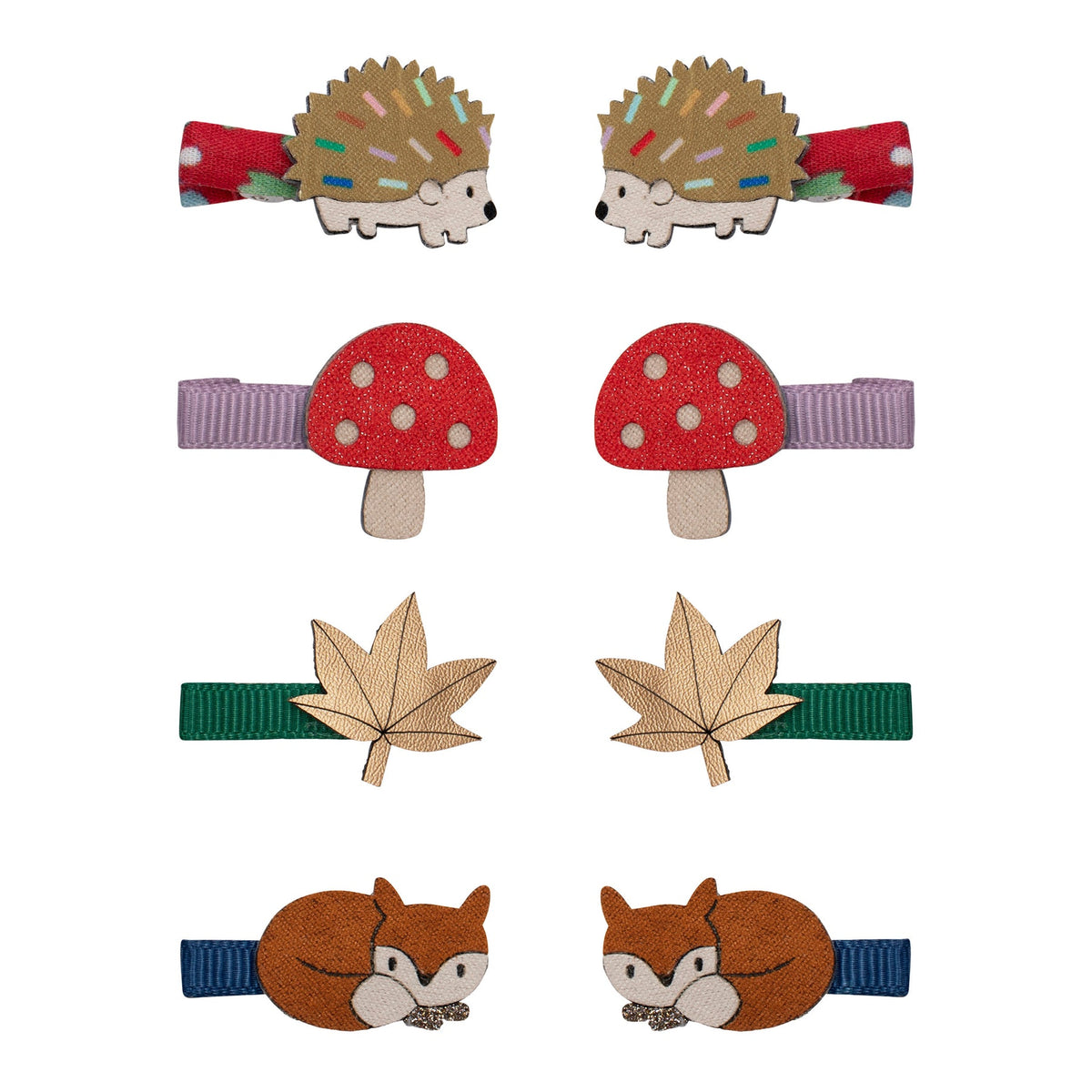 Set of animal-themed hair clips including hedgehogs, mushrooms, leaves, and foxes on a white background.