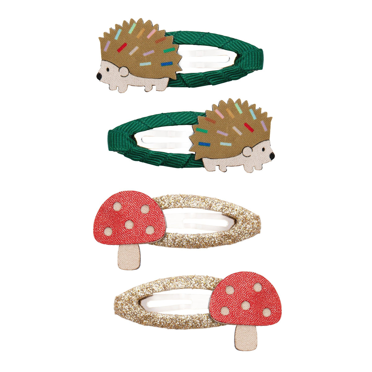 Set of three hair clips with hedgehog and mushroom designs on a white background