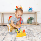 Child playing with toys on a carpeted floor