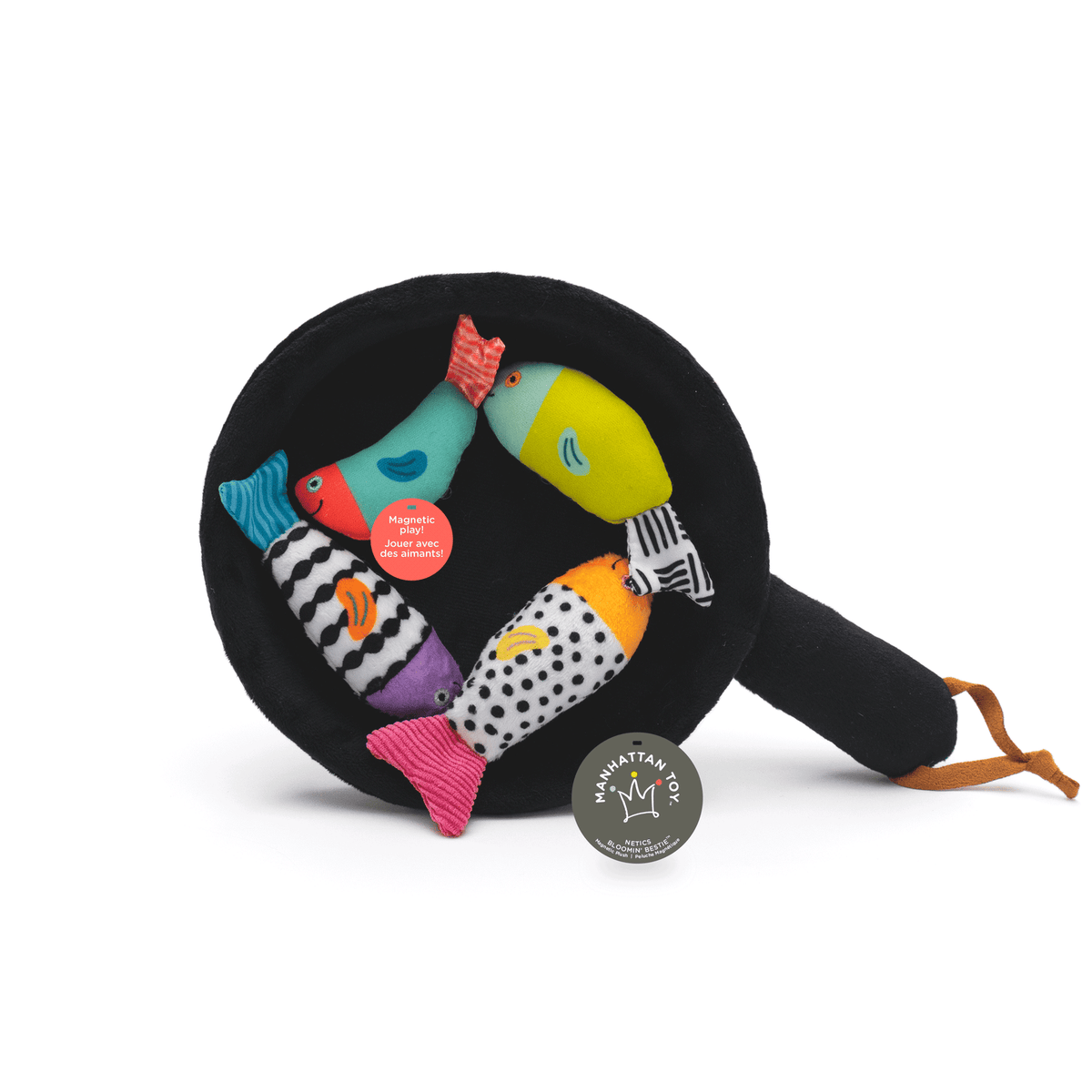 Colorful fish-shaped toys in a black frying pan with 'Manhattan Toy' branding.