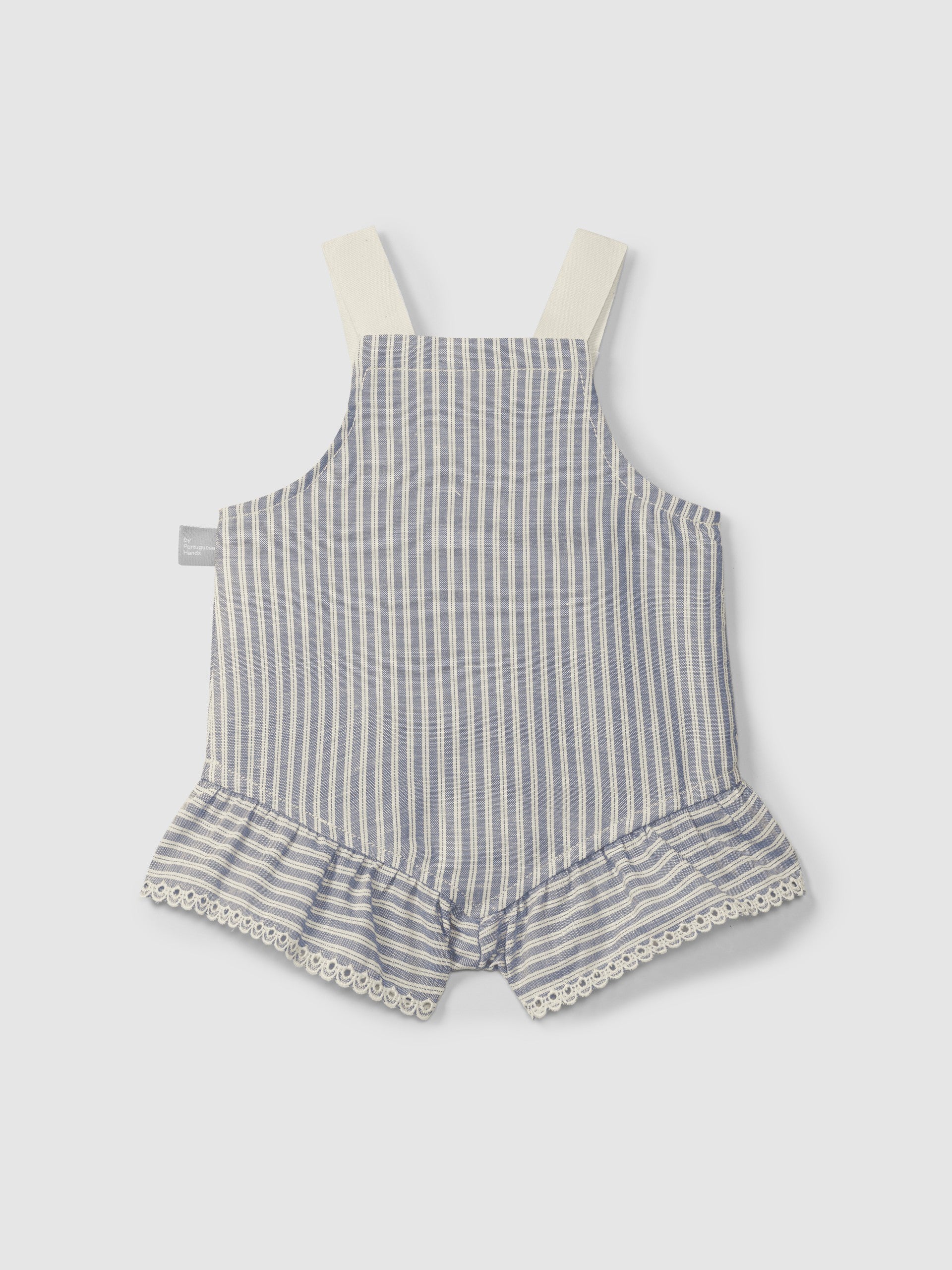 Striped baby romper with ruffled bottom on a light gray background