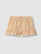 Striped shorts with ruffled hem on a light gray background